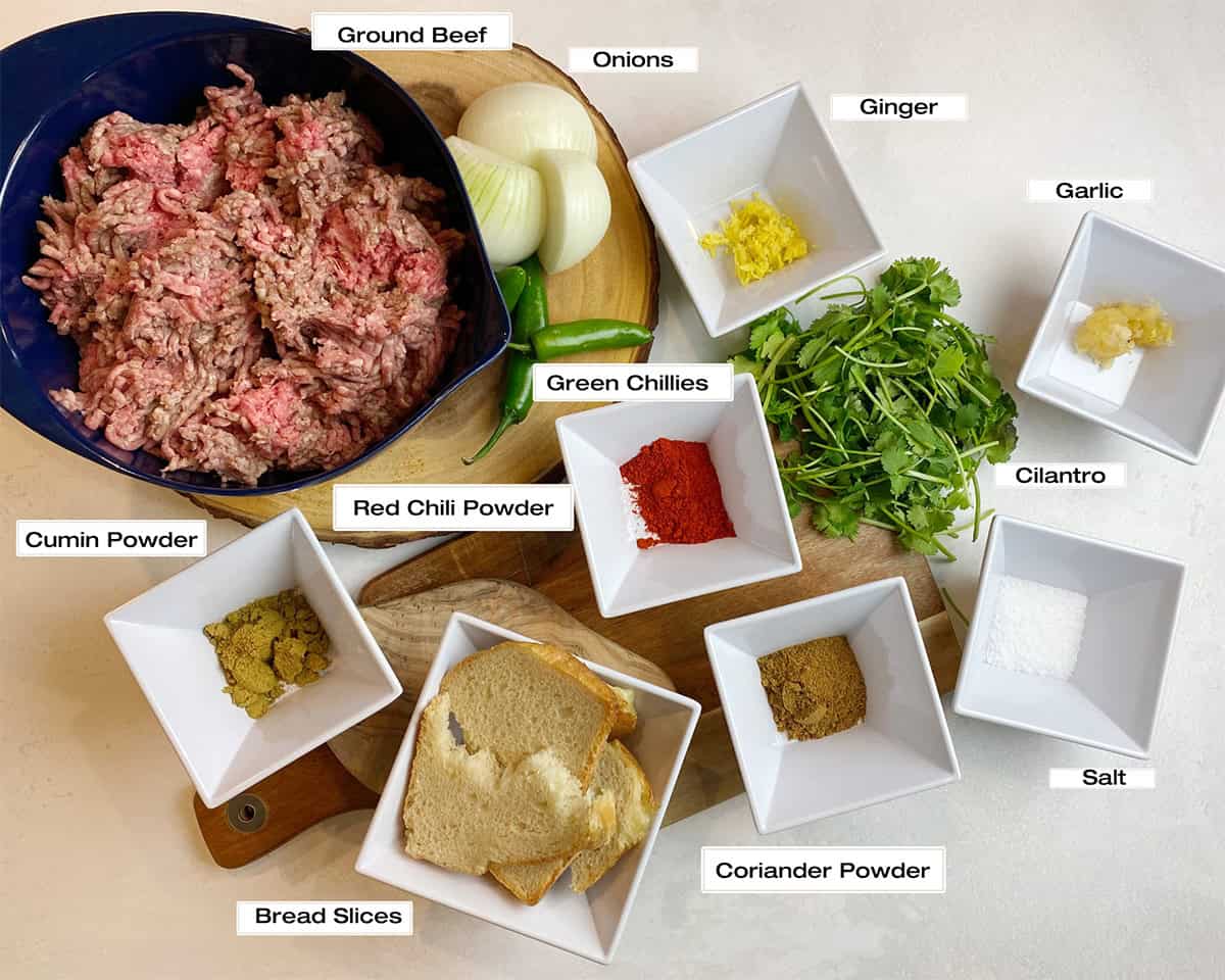 The measured ingredients to make beef meatballs are sitting on a kitchen counter.