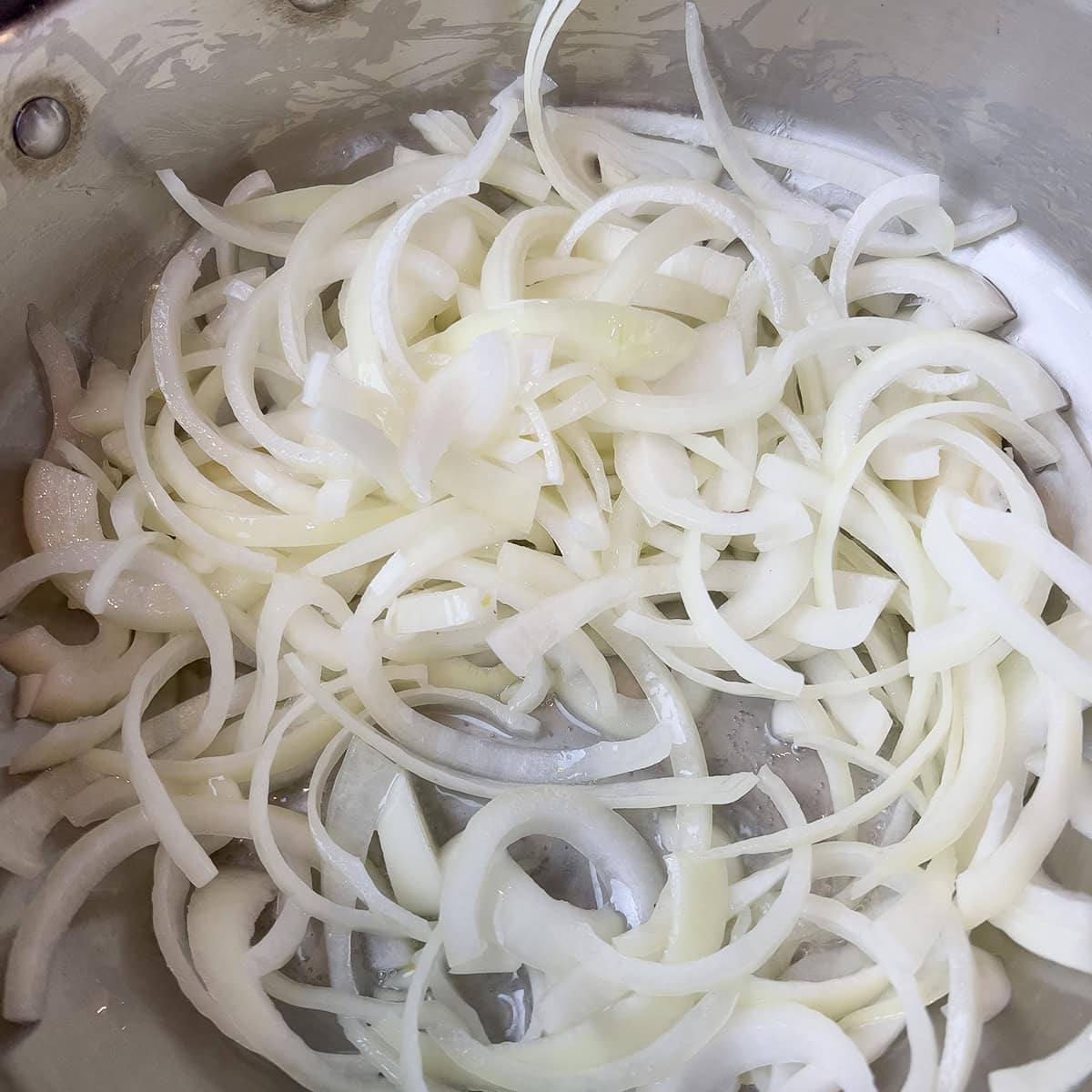 Onions being sauteed for a pulao recipe.
