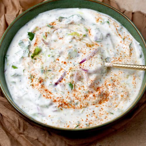 Yogurt raita with cucumber, red onion, cilantro and spices.