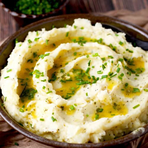 Mashed potatoes topped with butter and chives.