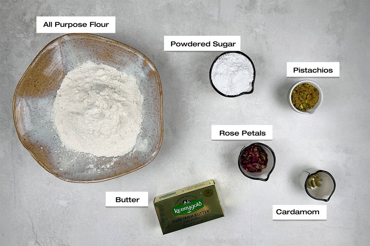 Ingredients for a Pakistani inspired holiday cookie recipe are lying on a white counter.