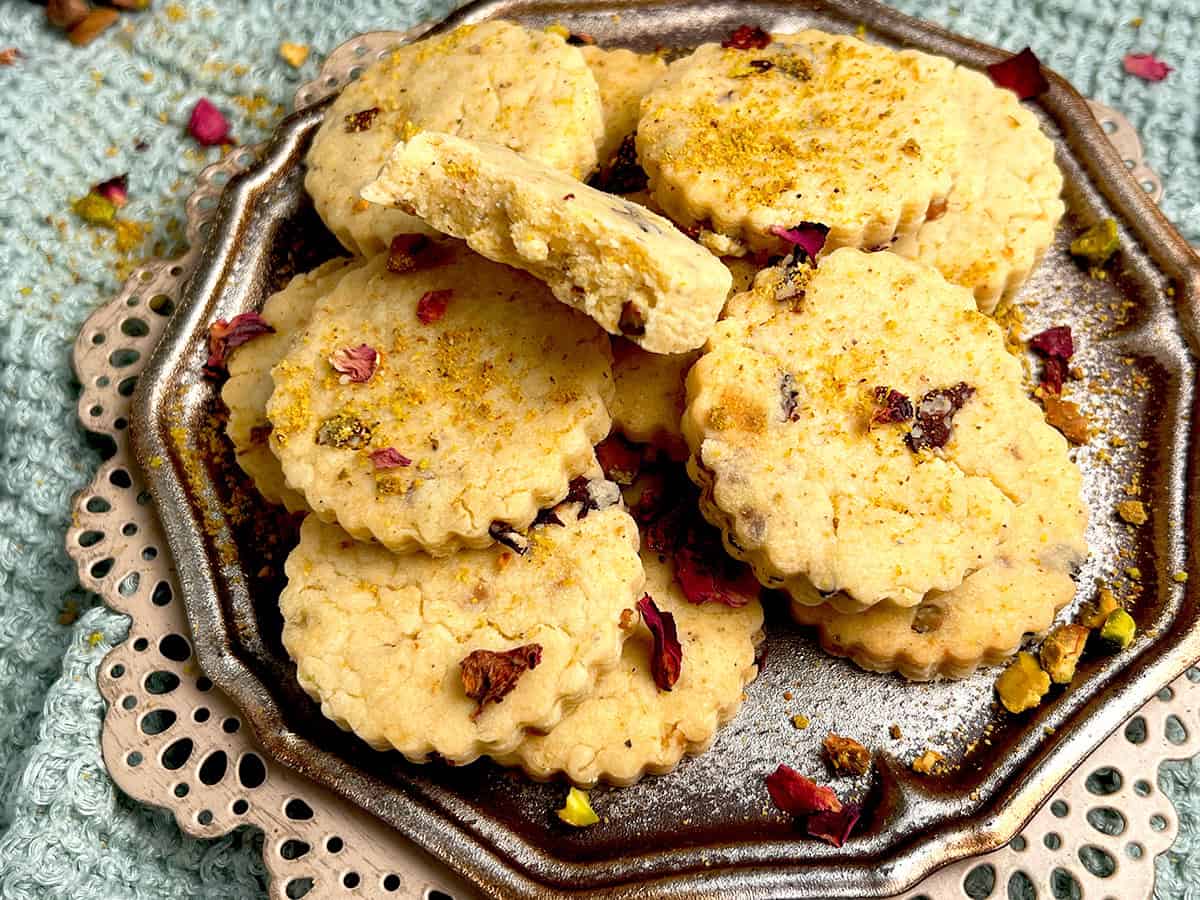 A plate of rose, pistachio,  and cardamom shortbread cookies.