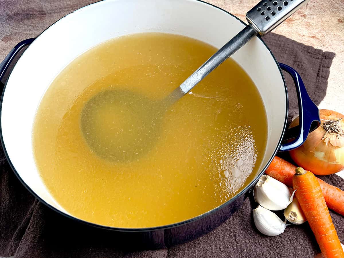 Homemade chicken broth cooked with bone-in chicken and vegetables.