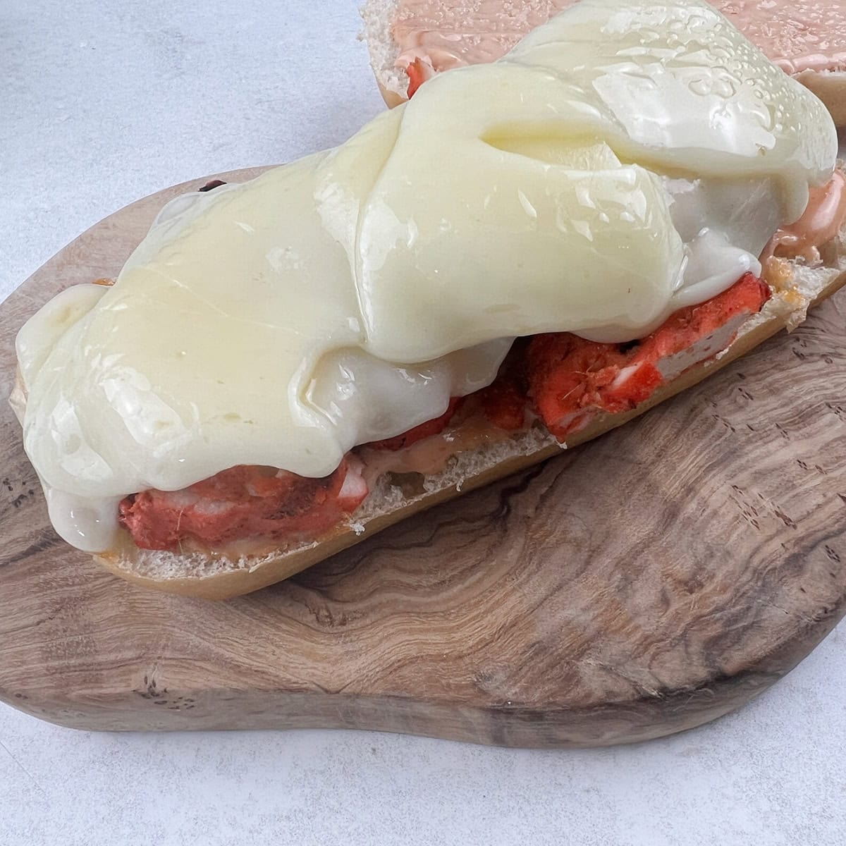 A sandwich with melted cheese.