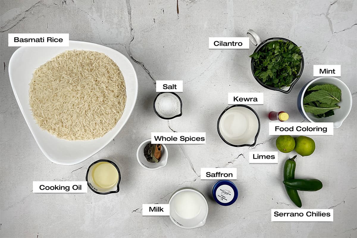 Ingredients to prepare rice for a biryani recipe are lying on a kitchen counter.