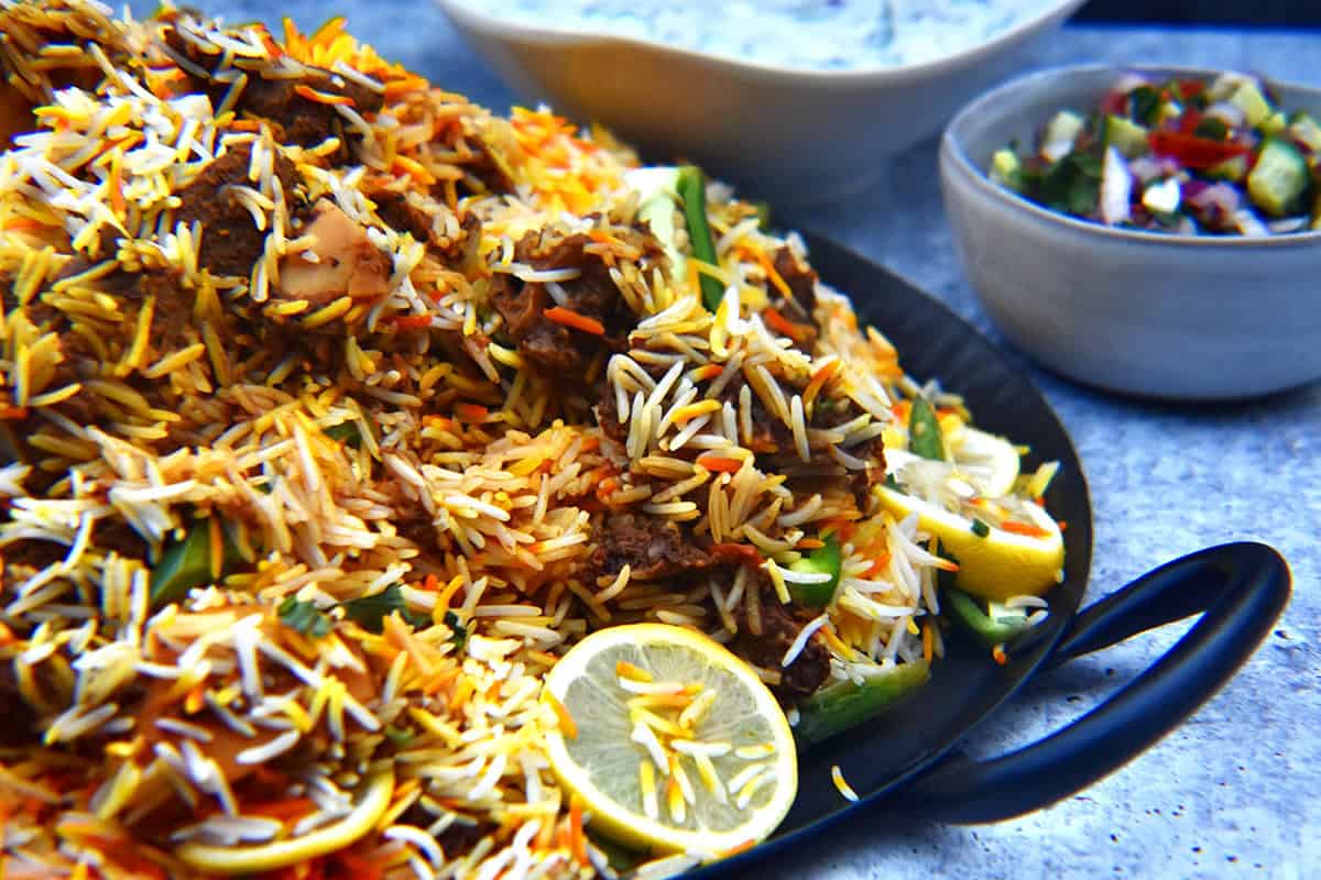 Freshly cooked mutton biryani recipe is plated and ready to be served.