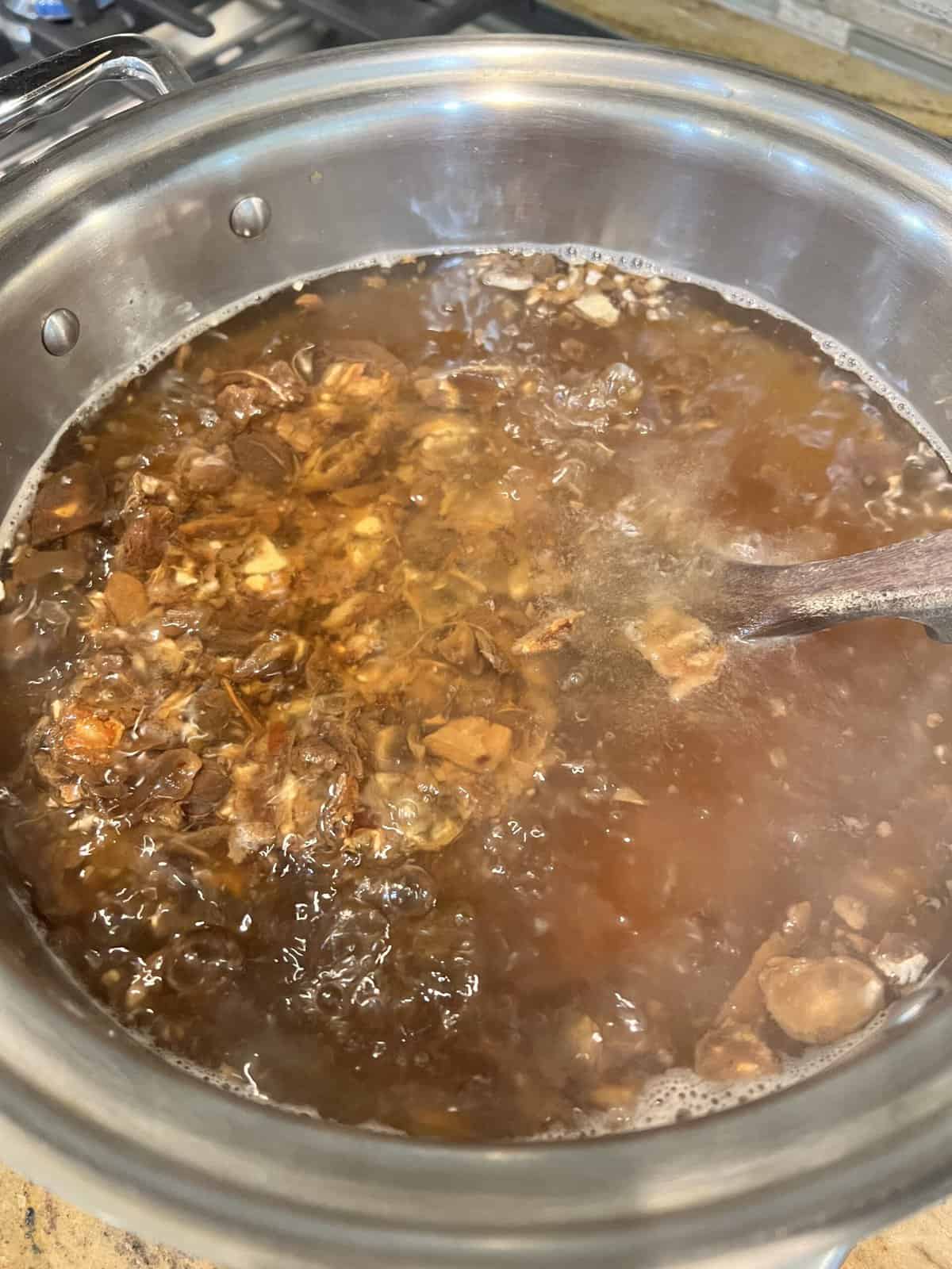 tamarind soaking in a stainless steel pot.