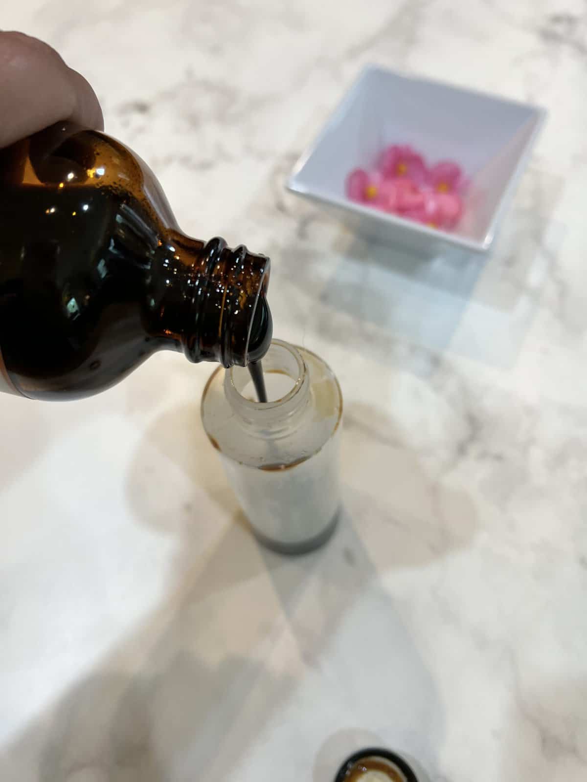 pomegranate molasses being poured into a small bottle.