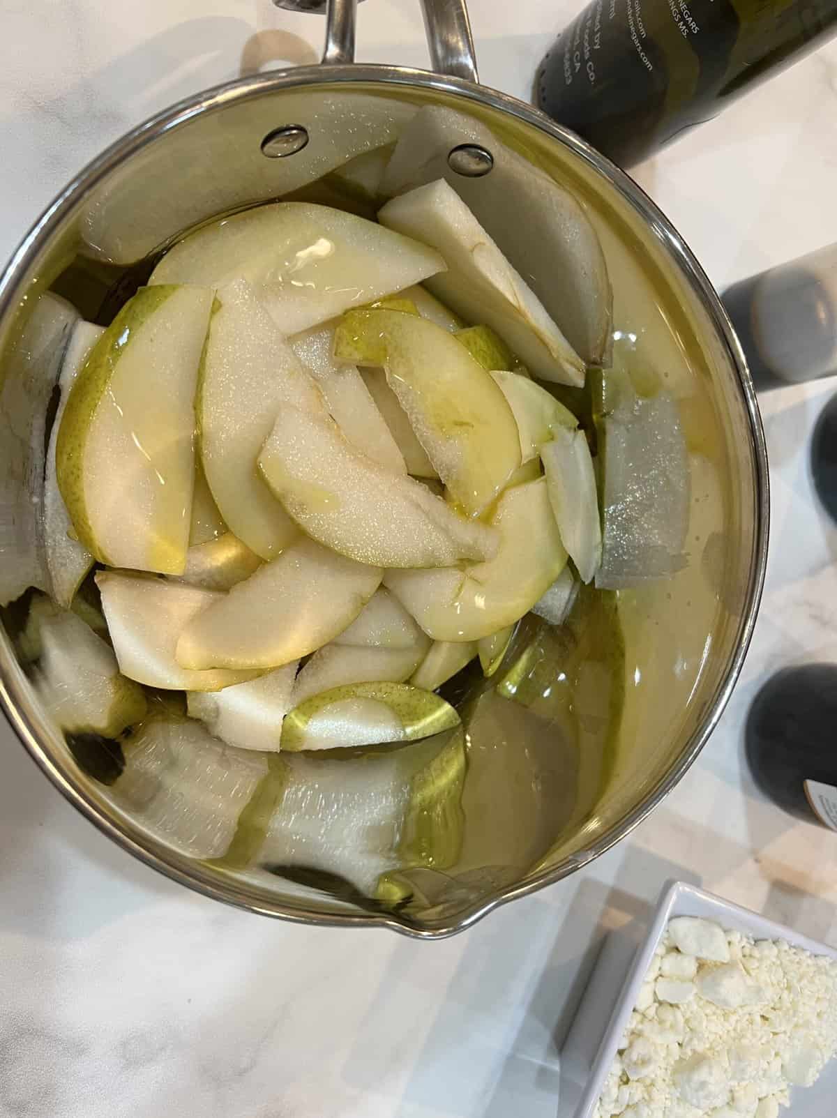 sliced pears in a metal bowl.