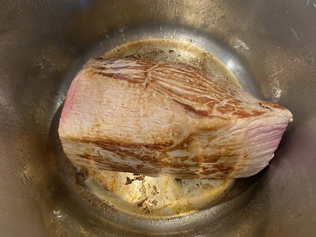 A seared beef eye of round in an Instant Pot .