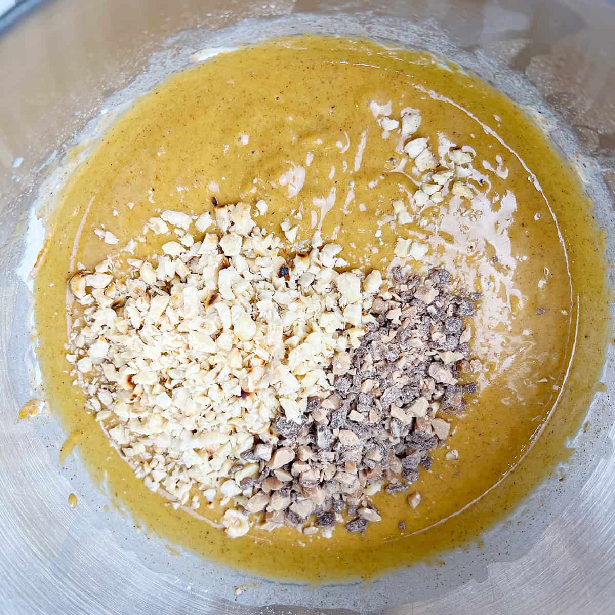 Pumpkin bread batter with hazelnuts and heath toffee bits.