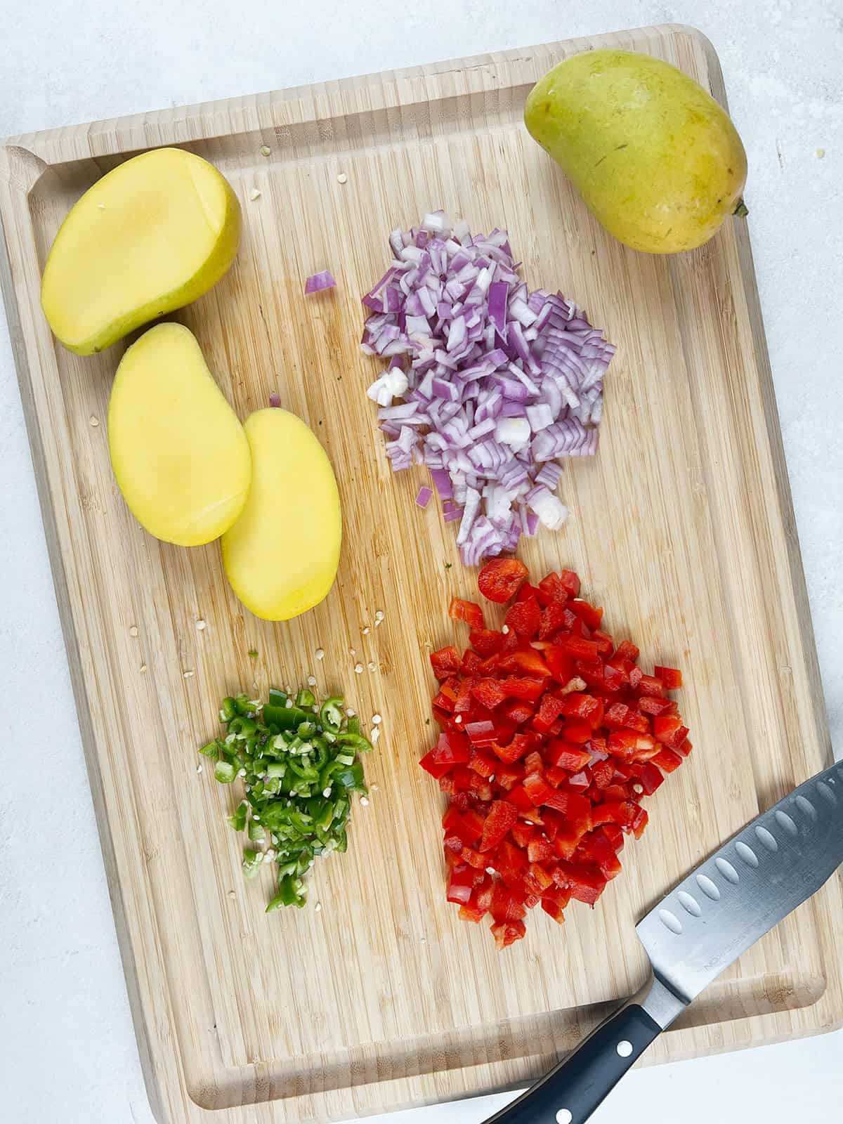 chopped ingredients for a fresh mango and black bean salsa.