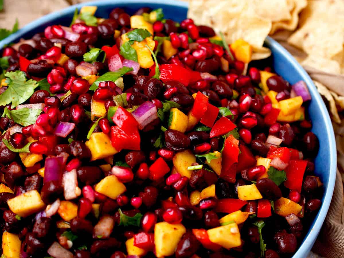 mango black bean salsa garnished with pomegranate seeds.