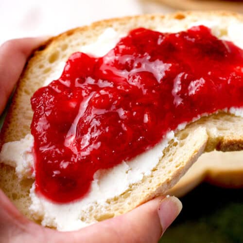 Homemade plum jam on a piece of bread.