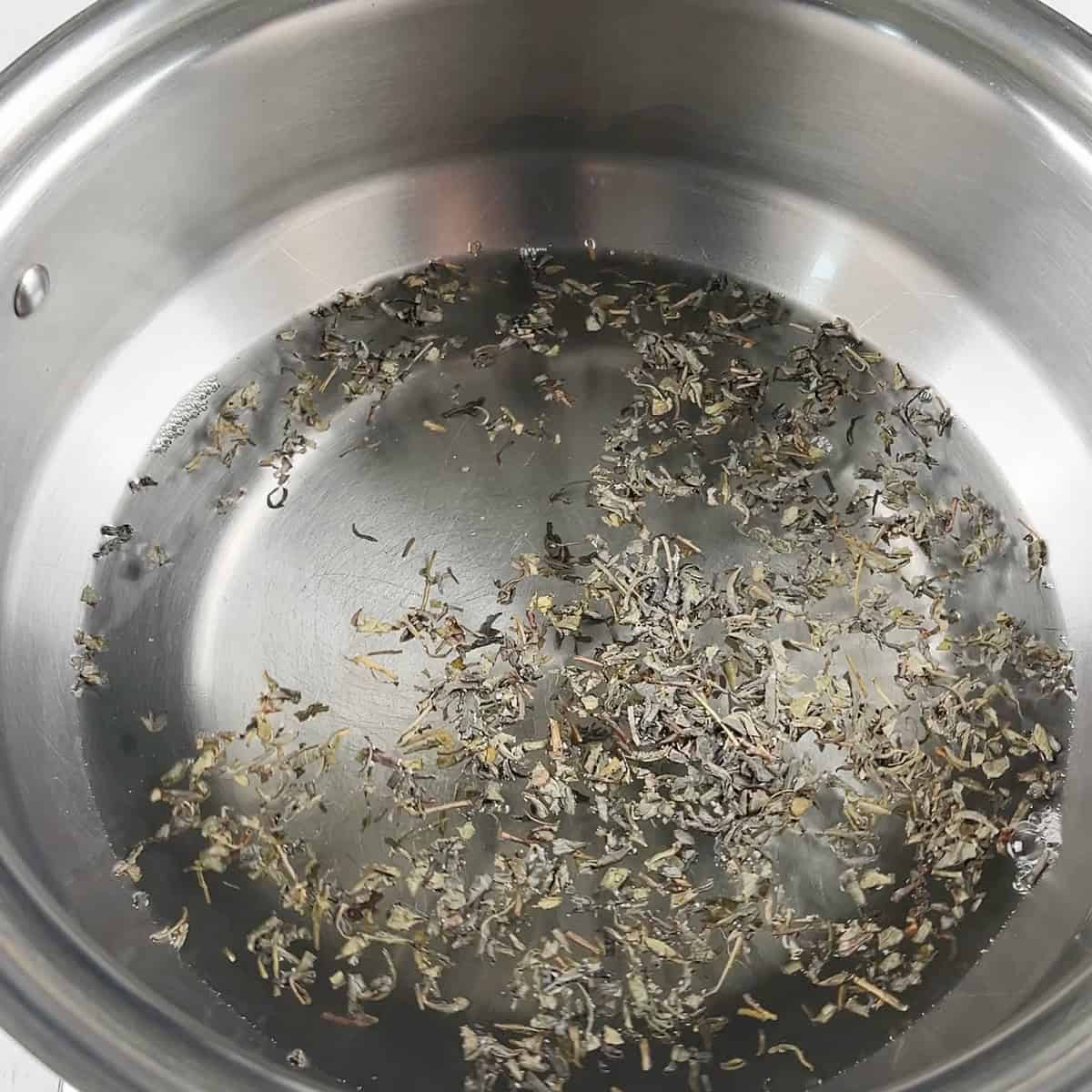Water and Kashmiri tea leaves in a pot.