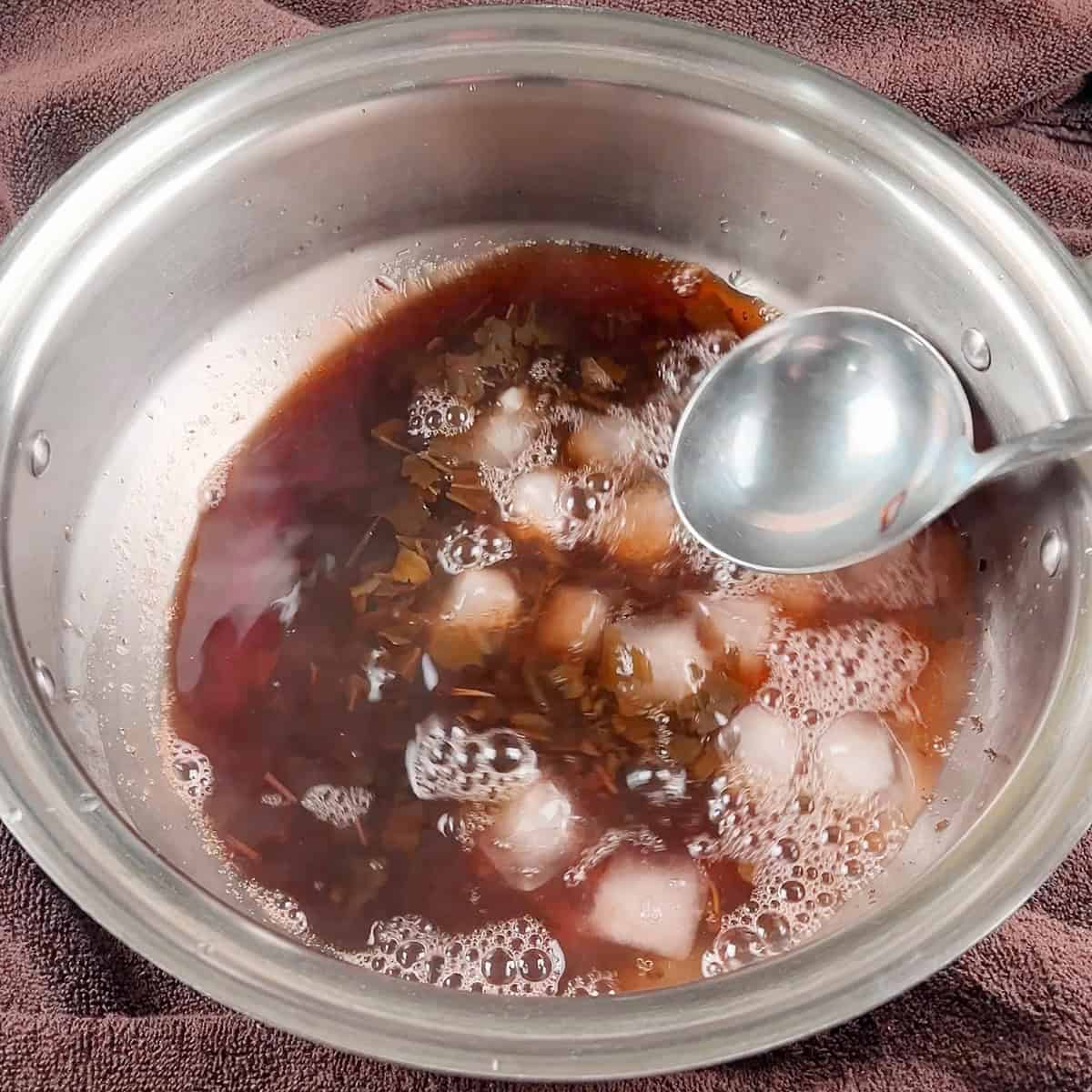 Ice and water mixture added to a Kashmiri pink tea mixture.