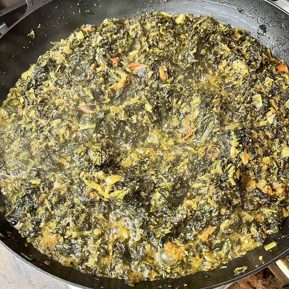 aloo palak in a black saute pan.