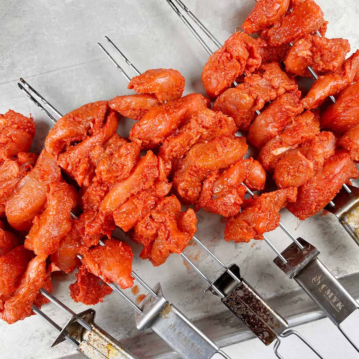 marinated chicken on metal skewers.