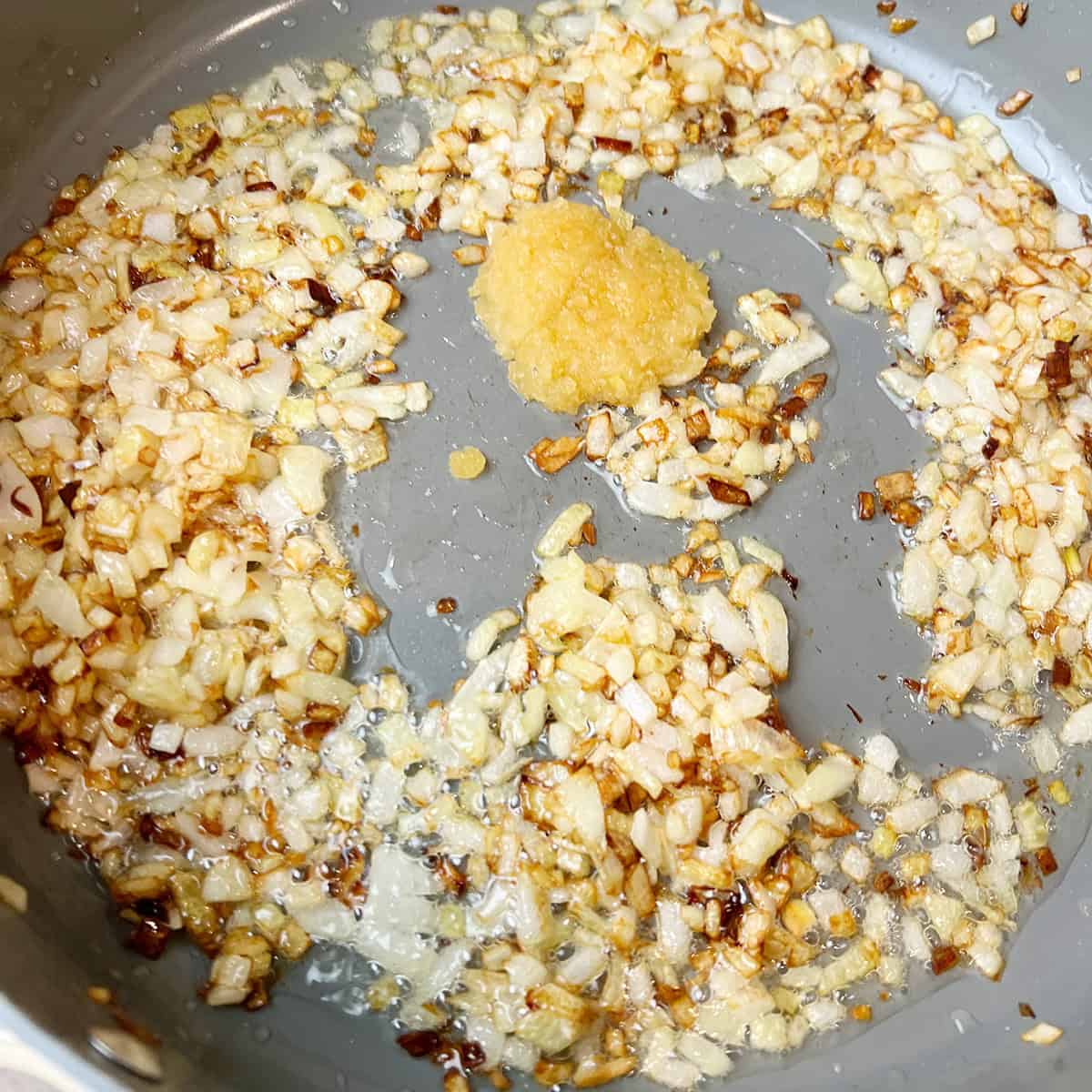onions and garlic paste are being sauteed.