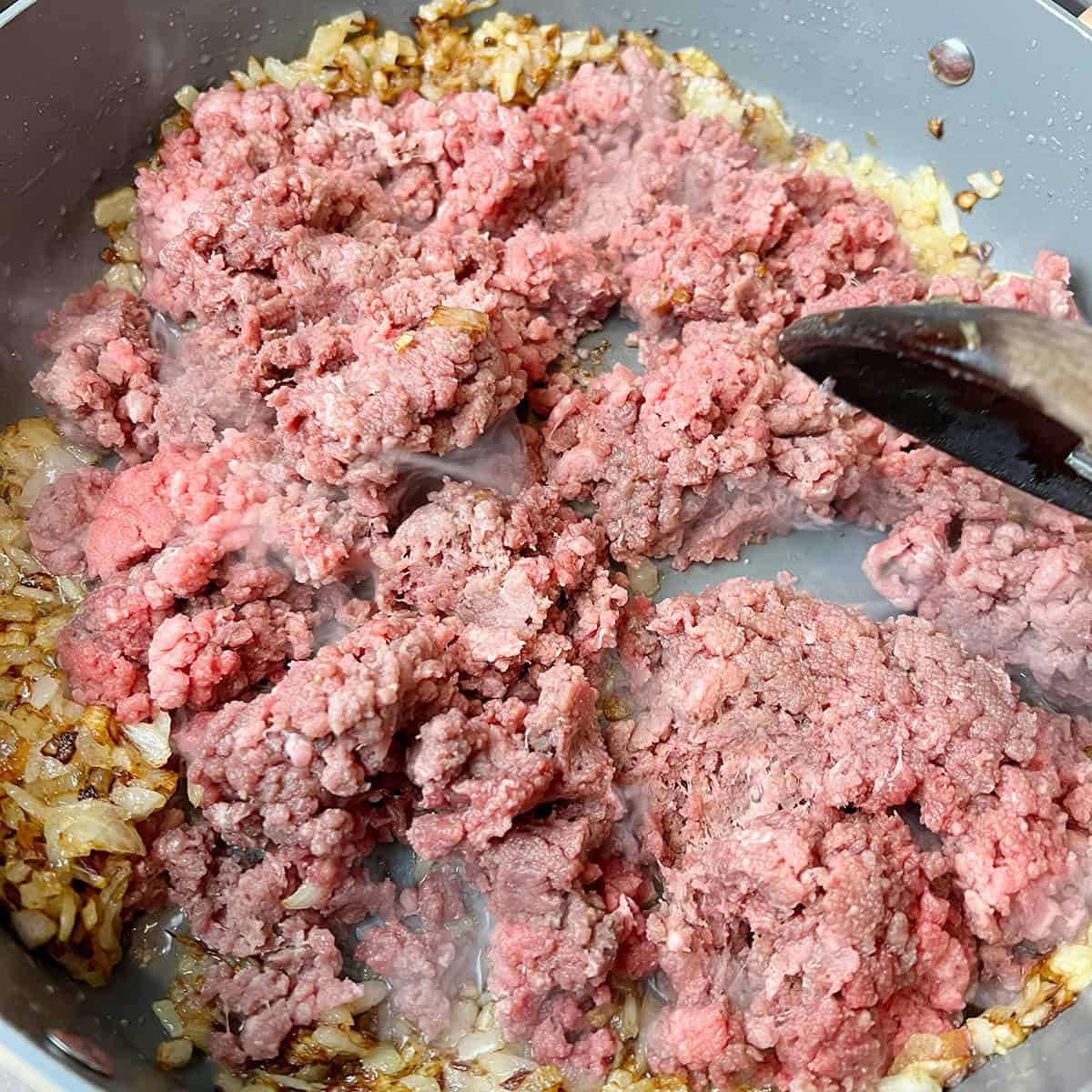A ground beef curry being cooked.