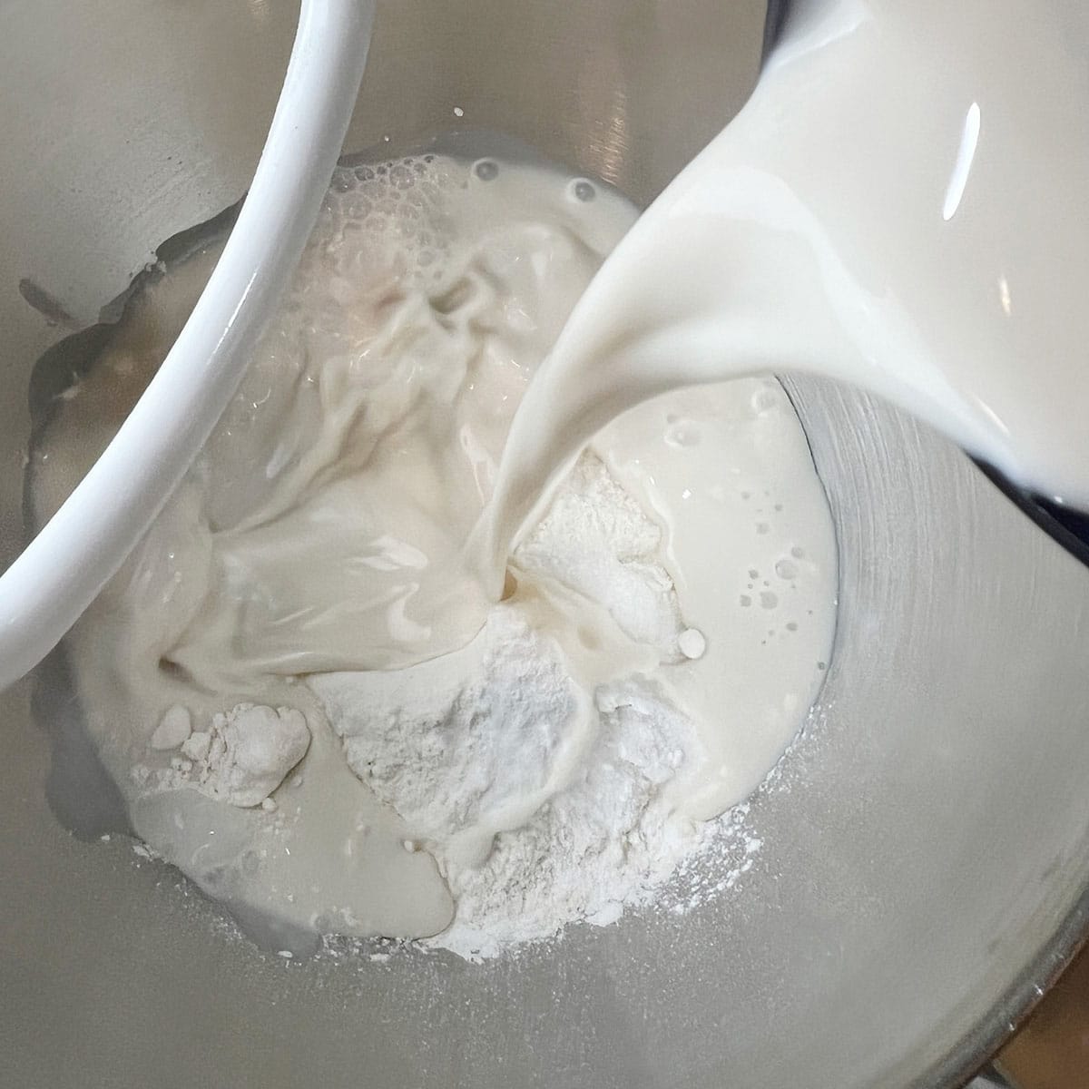 A kitchen Aid mixer is being used to mix a dough for an easy naan recipe.