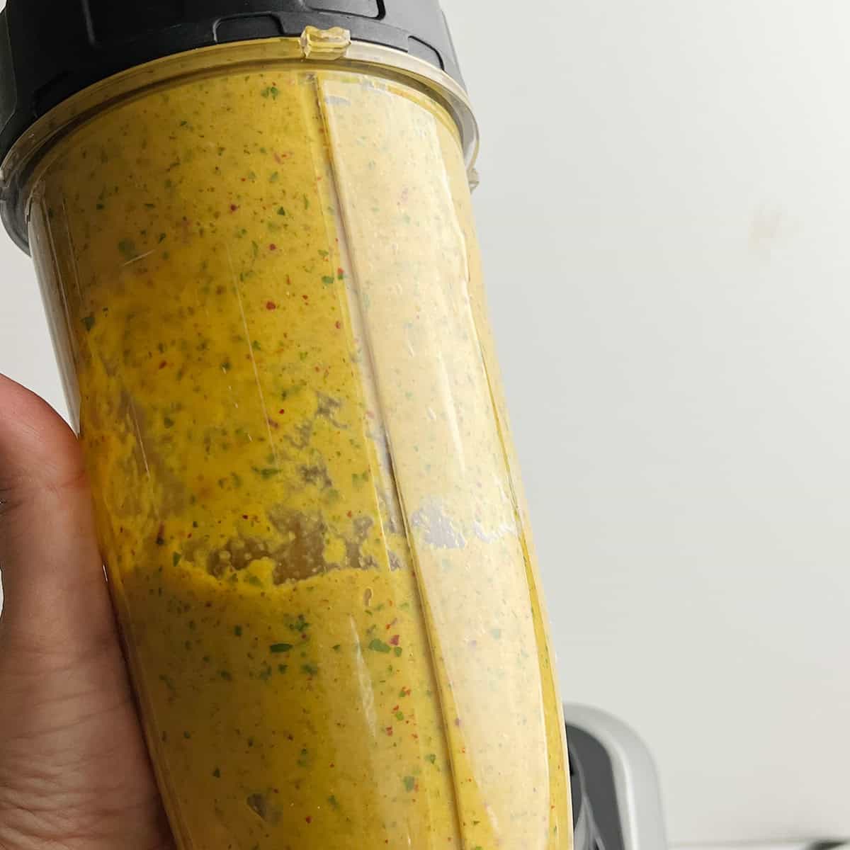 Freshly prepped mango chutney is in a blender jar.