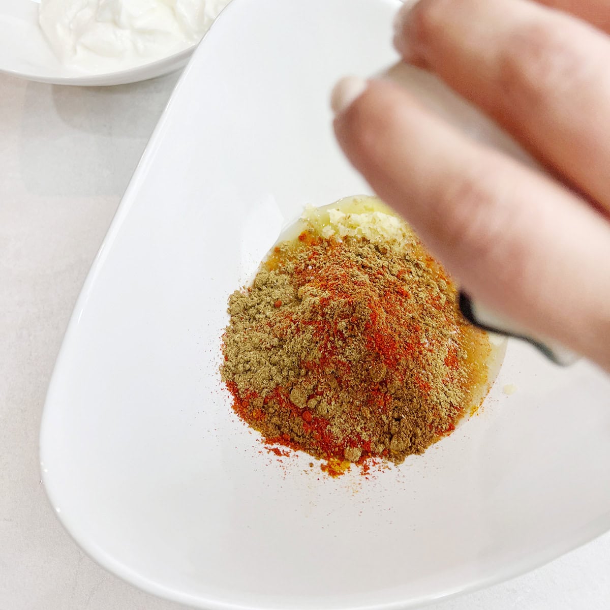 A Pakistani tandoori fish spice blend is being prepared.