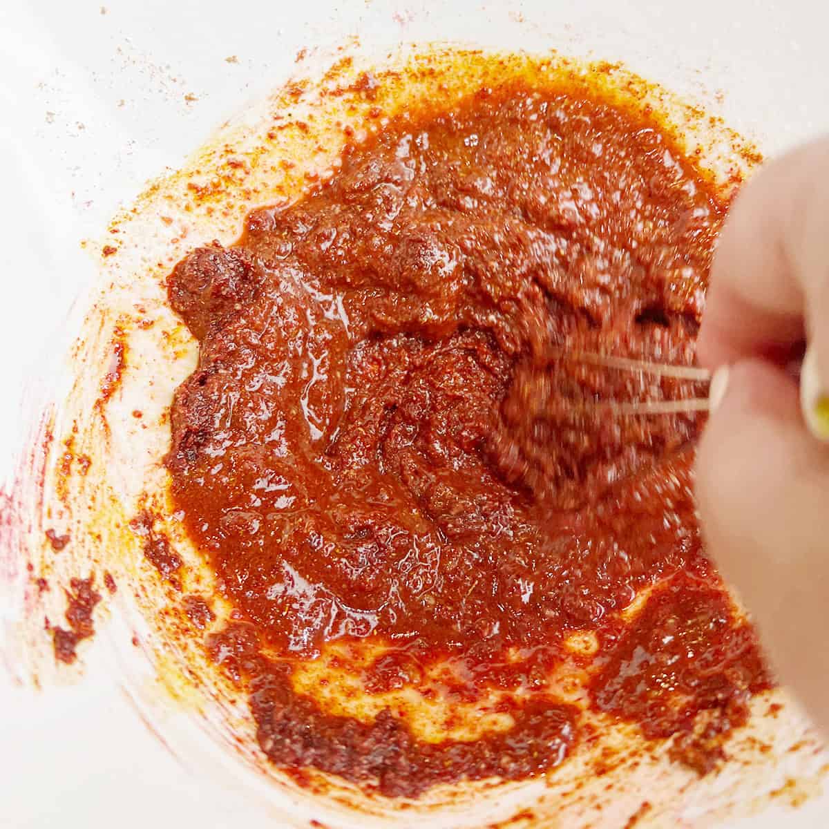 A spice blend is being mixed for a fish recipe.