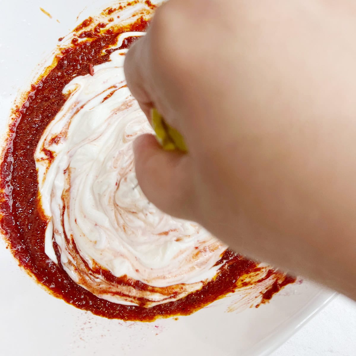 A yogurt marinade is being prepared for a pan seared fish recipe.