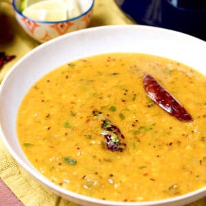 A freshly cooked bowl of a restaurant style lentil curry tempered with whole red chilies.