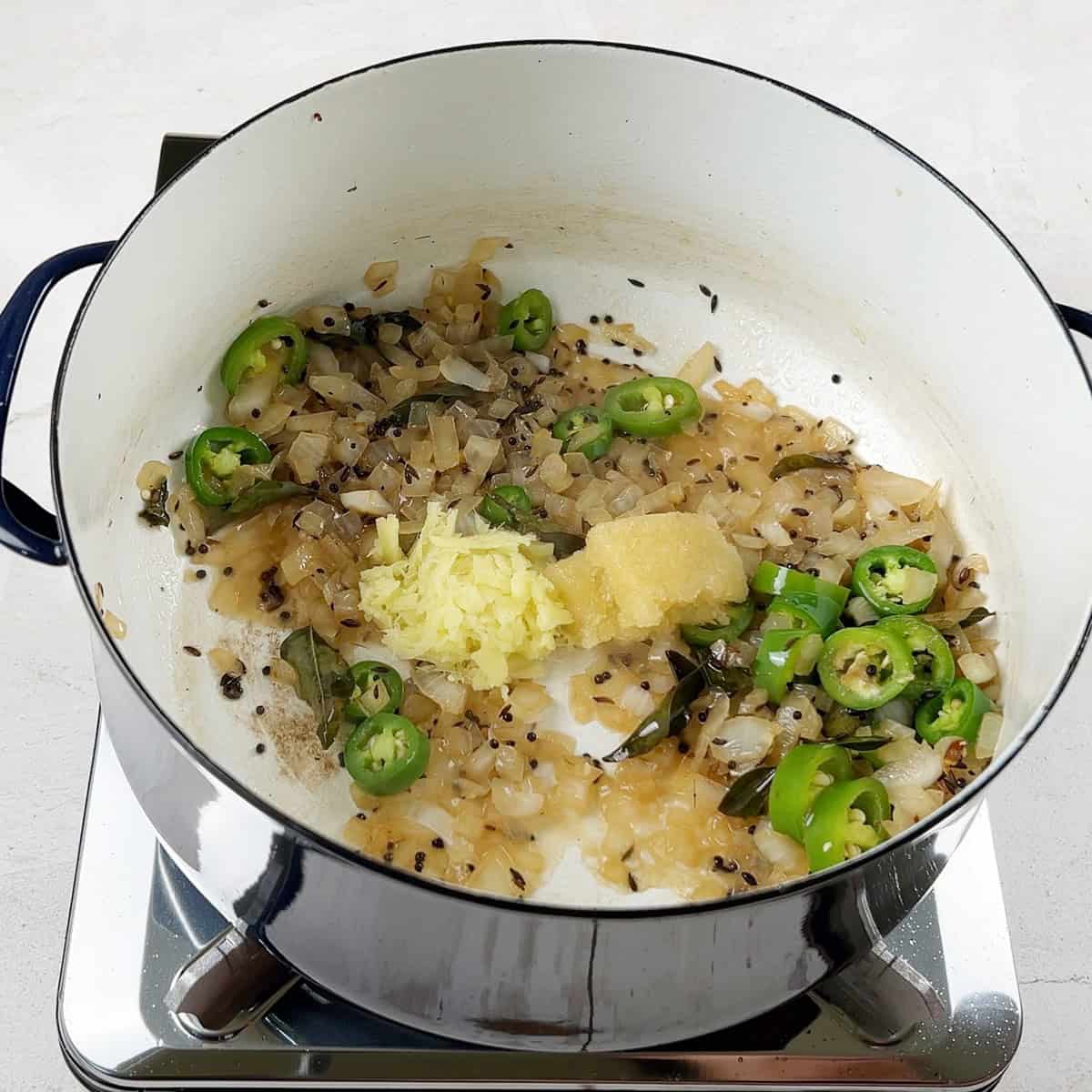 A masala base is being prepared for a Pakistani dal fry recipe.