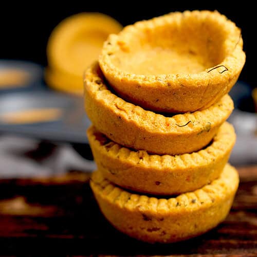 A freshly baked stack of savory cornmeal tarts are ready to be filled.