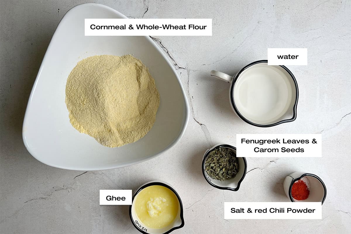 ingredients for a makki ki roti tart recipe are spread out on a white kitchen counter.