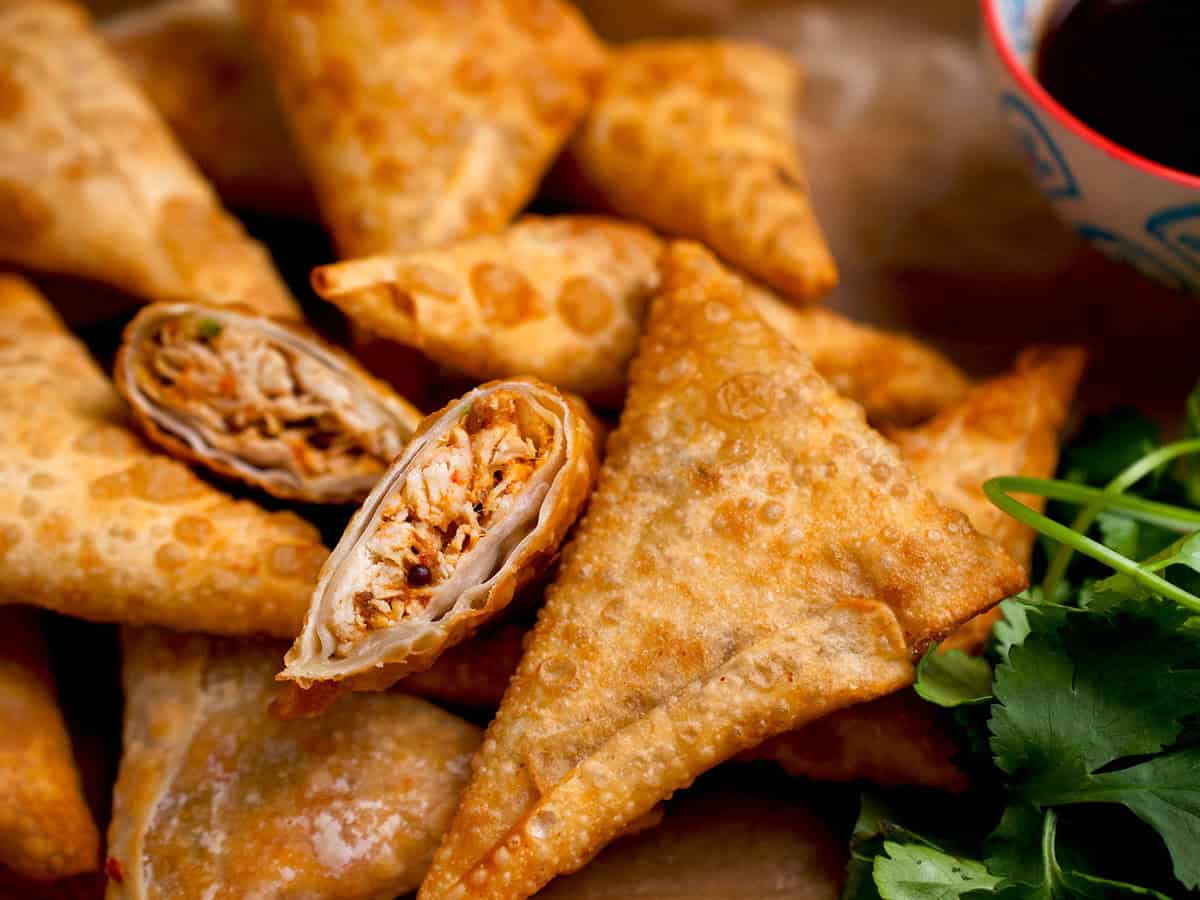 Cocktail samosas filled with chicken and a side of tamarind chutney.