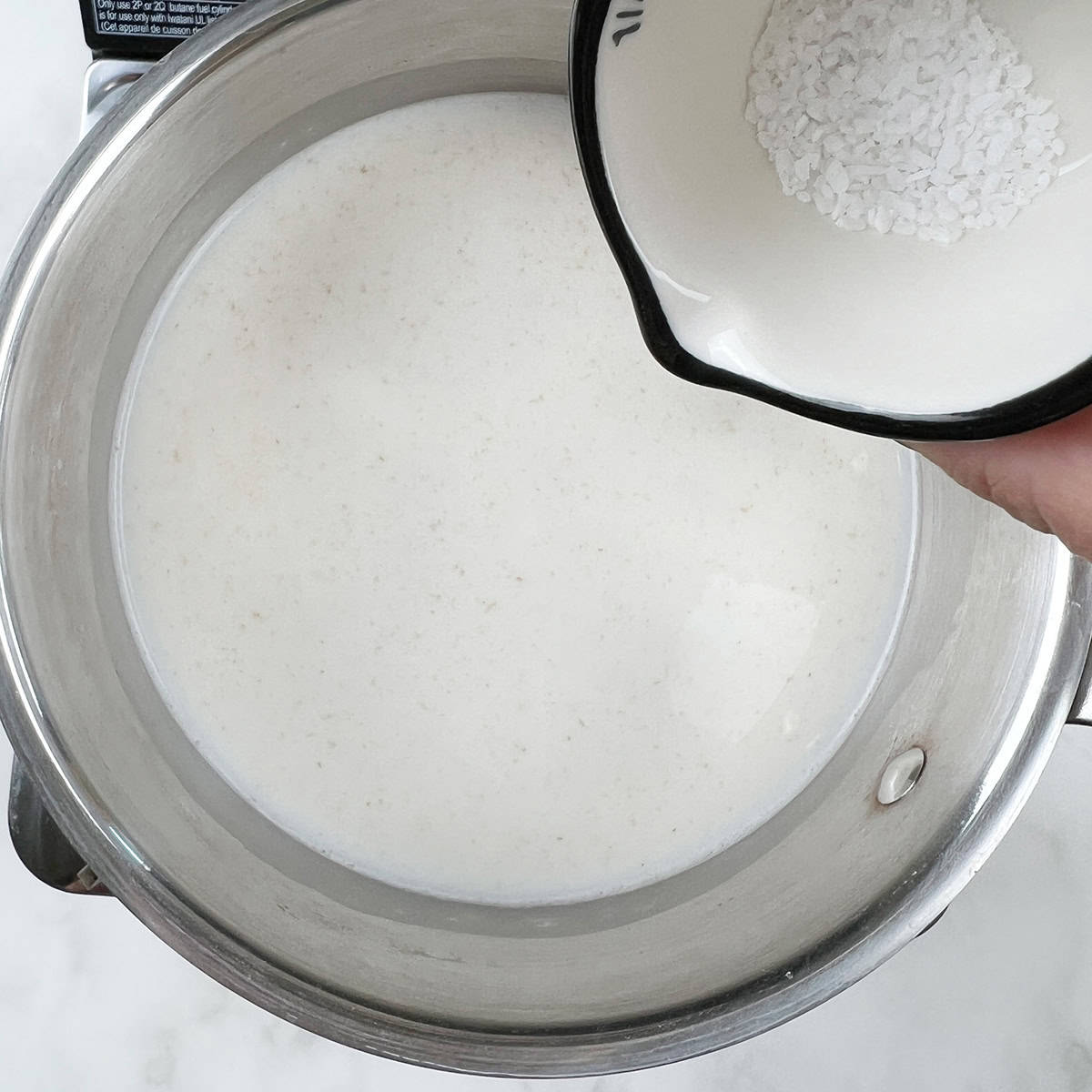 Salt is being added to oat porridge.