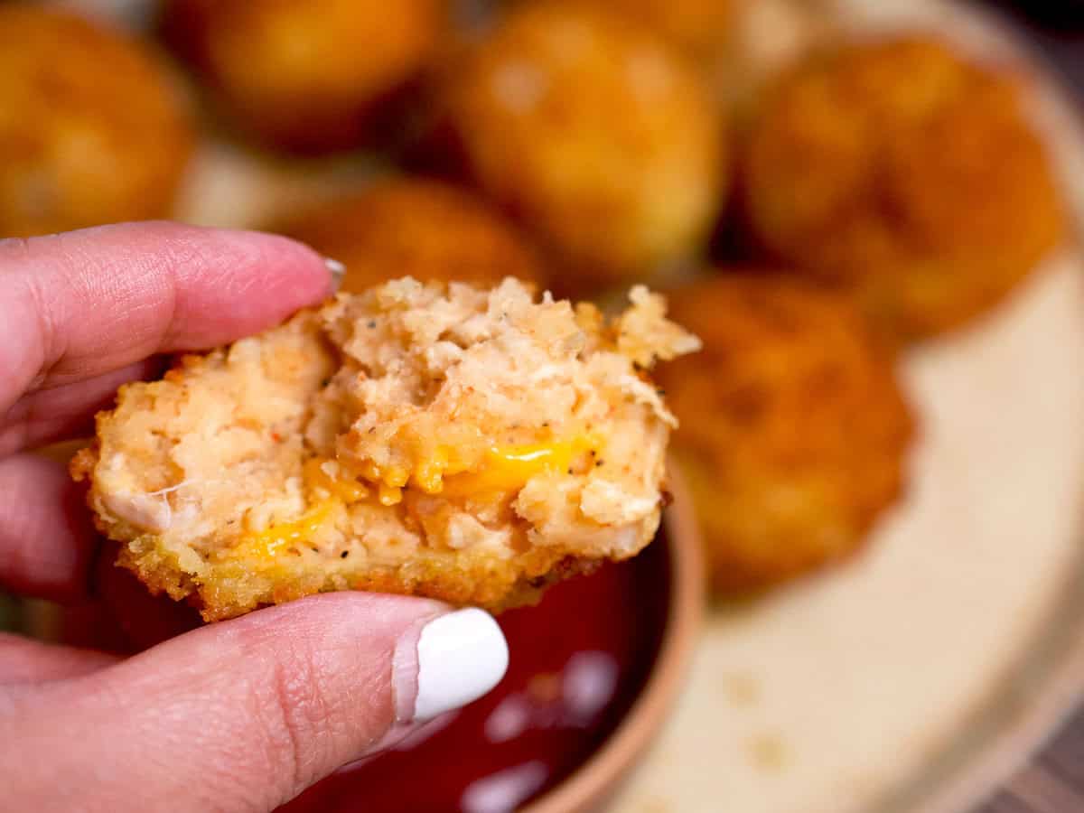 The inside of a freshly fried potato, chicken and cheese croquette.