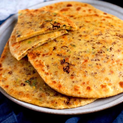 A keema paratha with a spicy cooked ground beef filling.