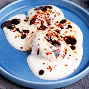 Dahi baras topped with masala and chutney.