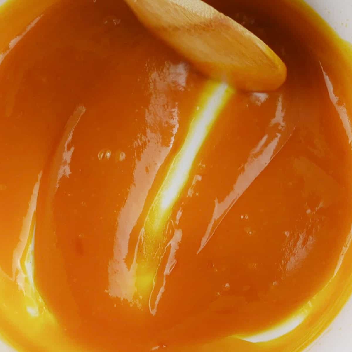 A mango pulp reduction for a dessert recipe.