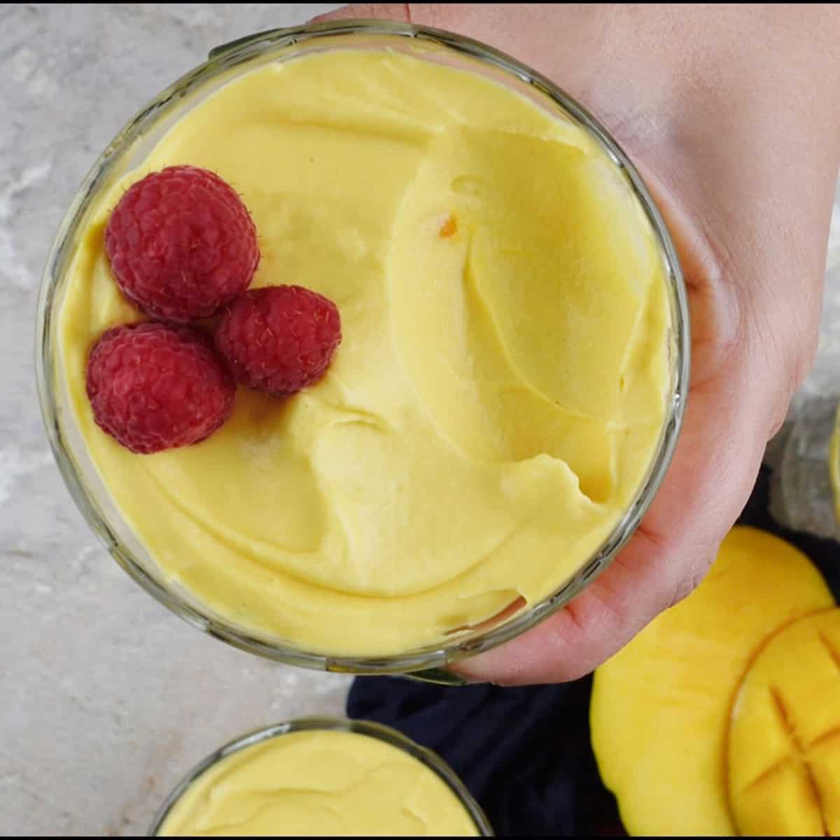 Mango mousse garnished with raspberries.