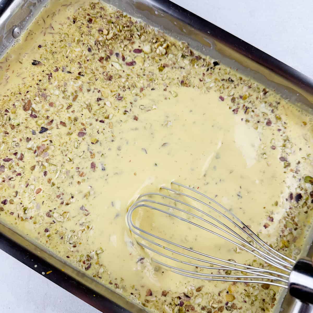 Homemade Pakistani ice cream being mixed.